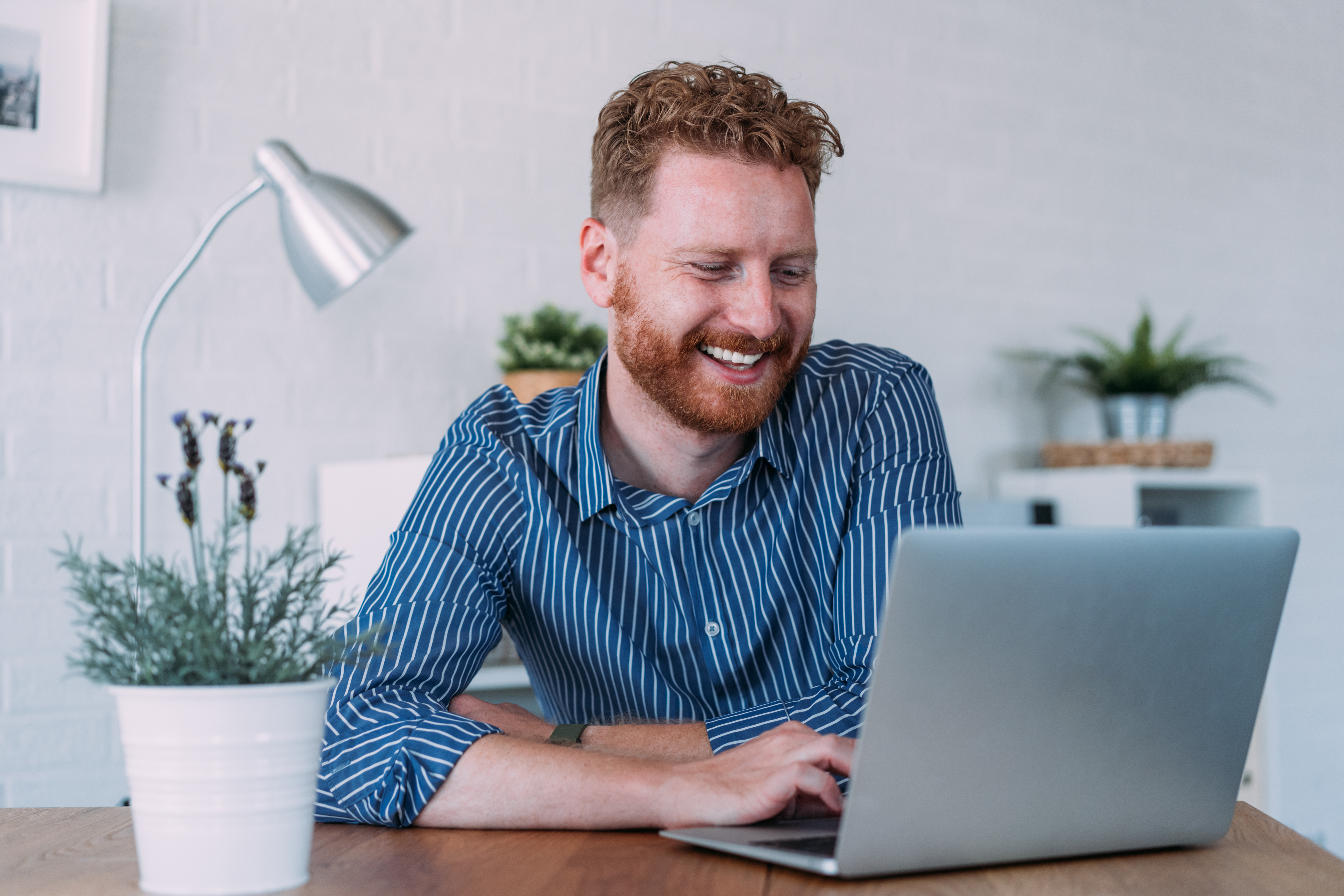 Mann sitzt vor Laptop